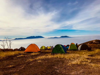 Tent on field against sky