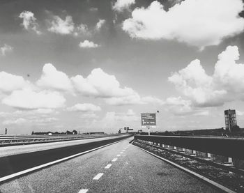 View of highway against cloudy sky