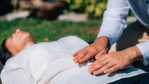 Reiki healing treatment. a therapist is performing a reiki energy healing treatment 