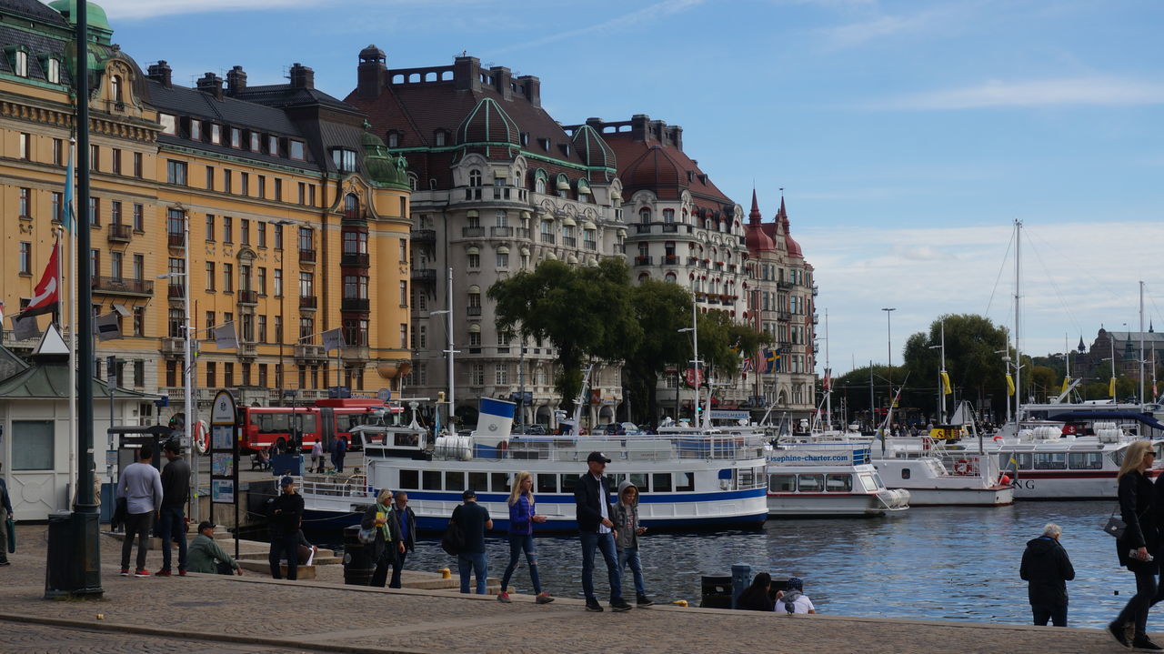 PEOPLE WALKING IN FRONT OF CANAL