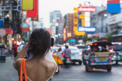 Rear view of woman in city street