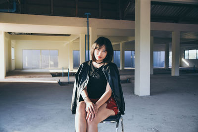 Portrait of beautiful young woman sitting at home