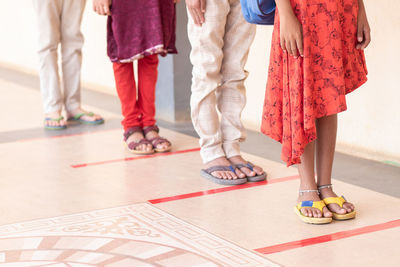 Low section of people standing on floor