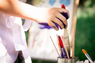 Baby draws brushes on nature