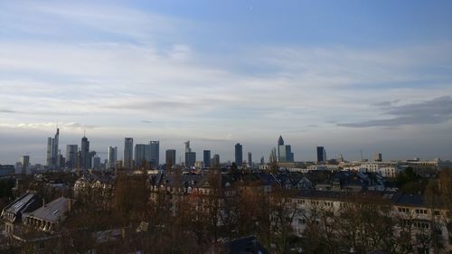 View of cityscape against cloudy sky