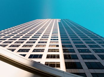 Low angle view of modern building against clear blue sky