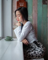 Portrait of young woman drinking glass