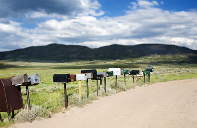 Scenic view of field and mountains against sky