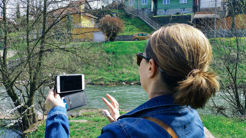 Close-up of woman taking picture through mobile phone