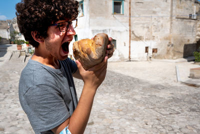 Young man holding seashell