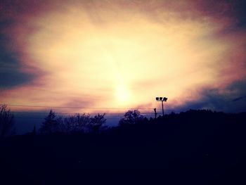 Silhouette landscape against sky during sunset