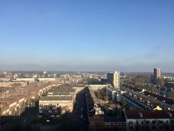 High angle view of buildings in city against clear sky