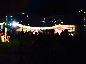 Defocused image of crowd at music concert at night