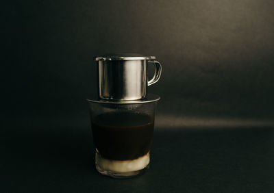 Close-up of coffee cup against black background