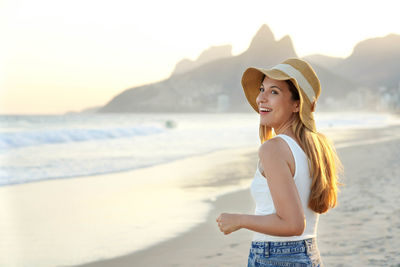 Carioca girl on ipanema beach at sunset, rio de janeiro, brazil