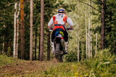 Man riding motorcycle on dirt road