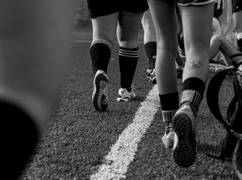 Low section of soccer players on field