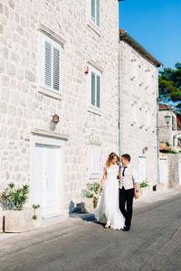 Couple walking on street during sunny day