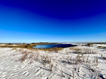 Scenic view of sea against clear blue sky