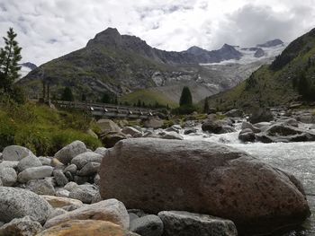 Scenic view of rocks and mountains against sky
