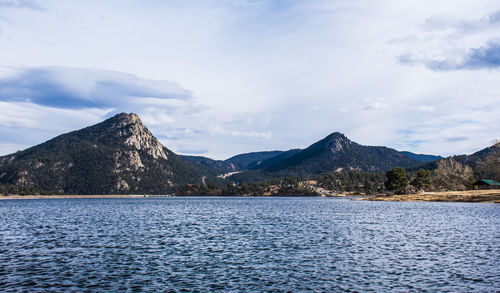 Scenic view of lake and mountains against sky