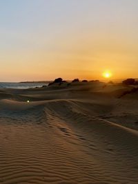 Scenic view of beach against sky during sunset