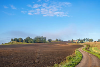 Agricultural land view with a winding country road