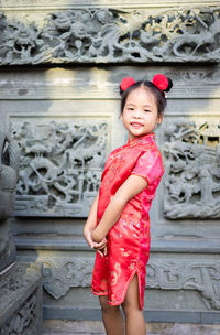 Portrait of smiling girl standing outdoors