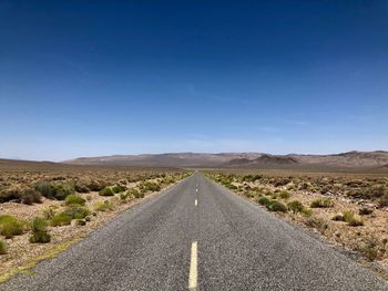 Road passing through landscape against sky