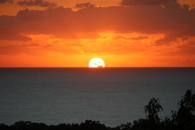 Scenic view of sea against orange sky