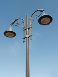 Low angle view of street light against sky