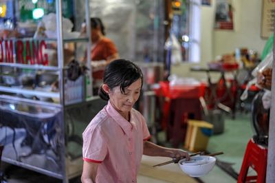 Rear view of a man standing in restaurant