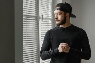 Portrait of mature man sitting by window