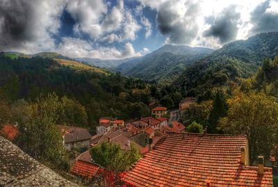 Scenic view of mountains against cloudy sky