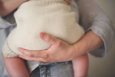 Mother holds her baby in eco-friendly diaper, conscious consumption 