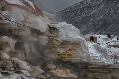 Low angle view of rock formations in snow