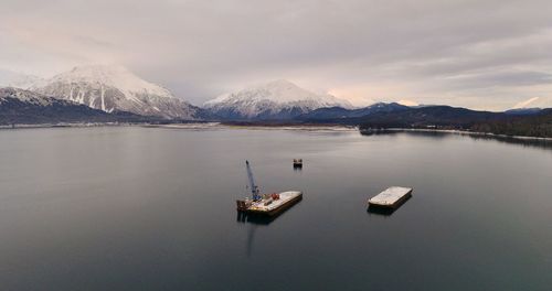 Scenic view of lake and mountains against sky