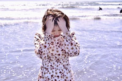 Full length of woman standing at beach