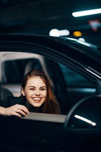 Portrait of young woman in car