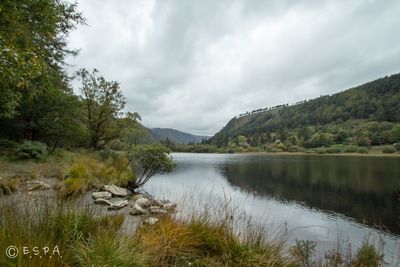 Scenic view of lake against cloudy sky