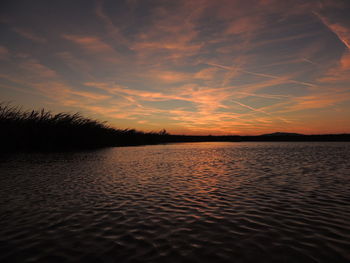 Scenic view of lake against sky during sunset