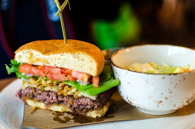 Bison burger with bowl served in plate