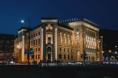 Illuminated buildings against sky at night