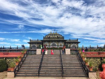 View of temple building against cloudy sky