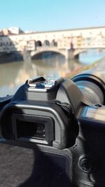 Close-up of camera and car against sky