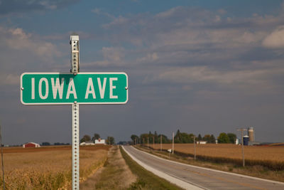 Road sign against sky