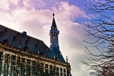 Low angle view of old building in city against sky during sunset