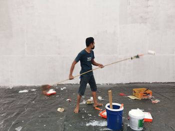 Full length of man working on wall