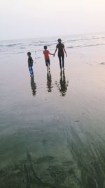 Friends standing on beach