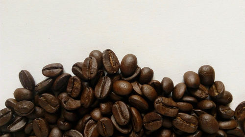 Close-up of coffee beans against white background